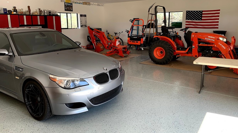 My dream garage. Tractor and M5. Show me a picture of a similar garage.